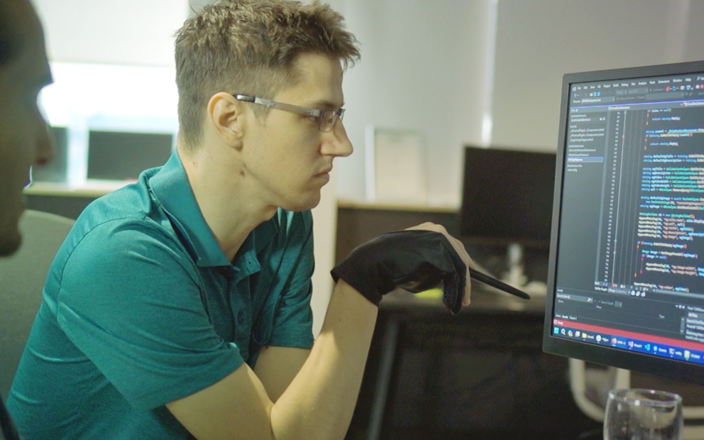 Two people working on computer screen