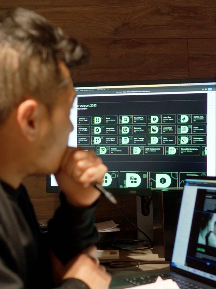 Image of man looking at computer screen.