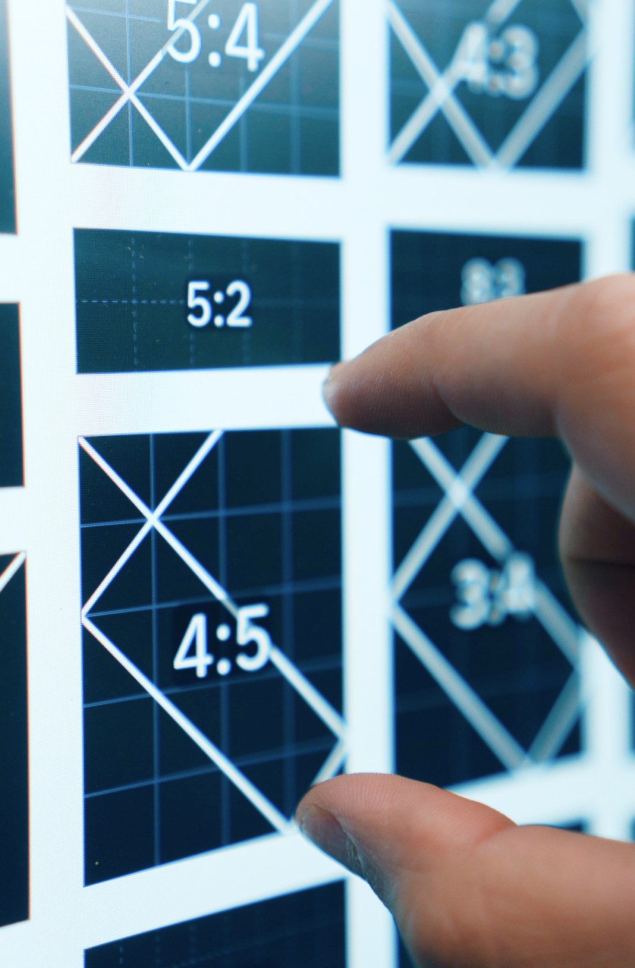 close of hand pointing at a graphic placeholder on computer screen.