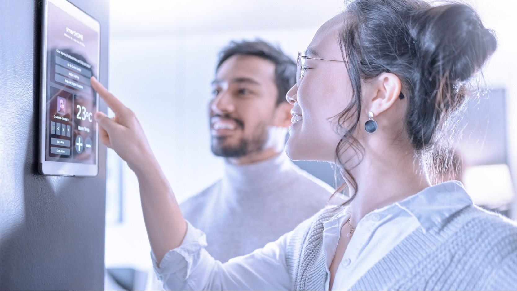 Couple testing the interface panel on a fridge.