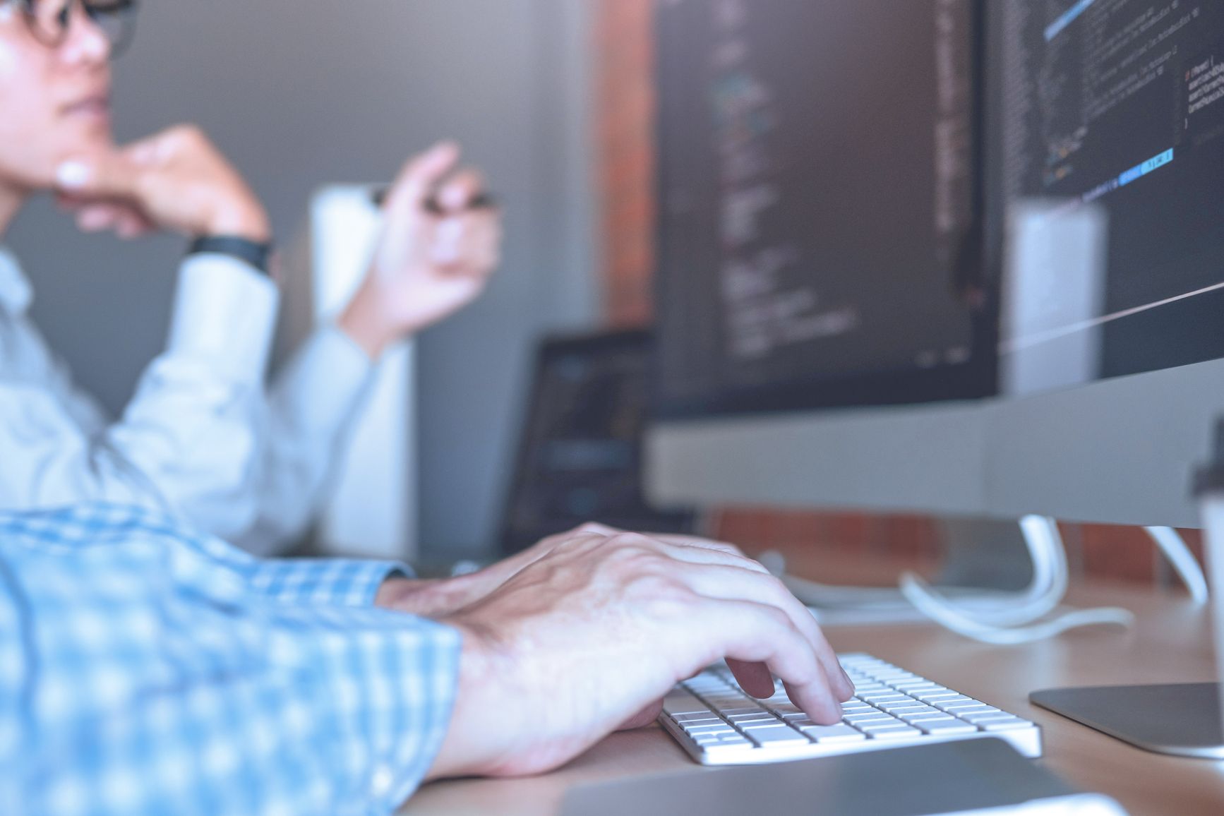 Colleagues reviewing together a segment of website code.  
