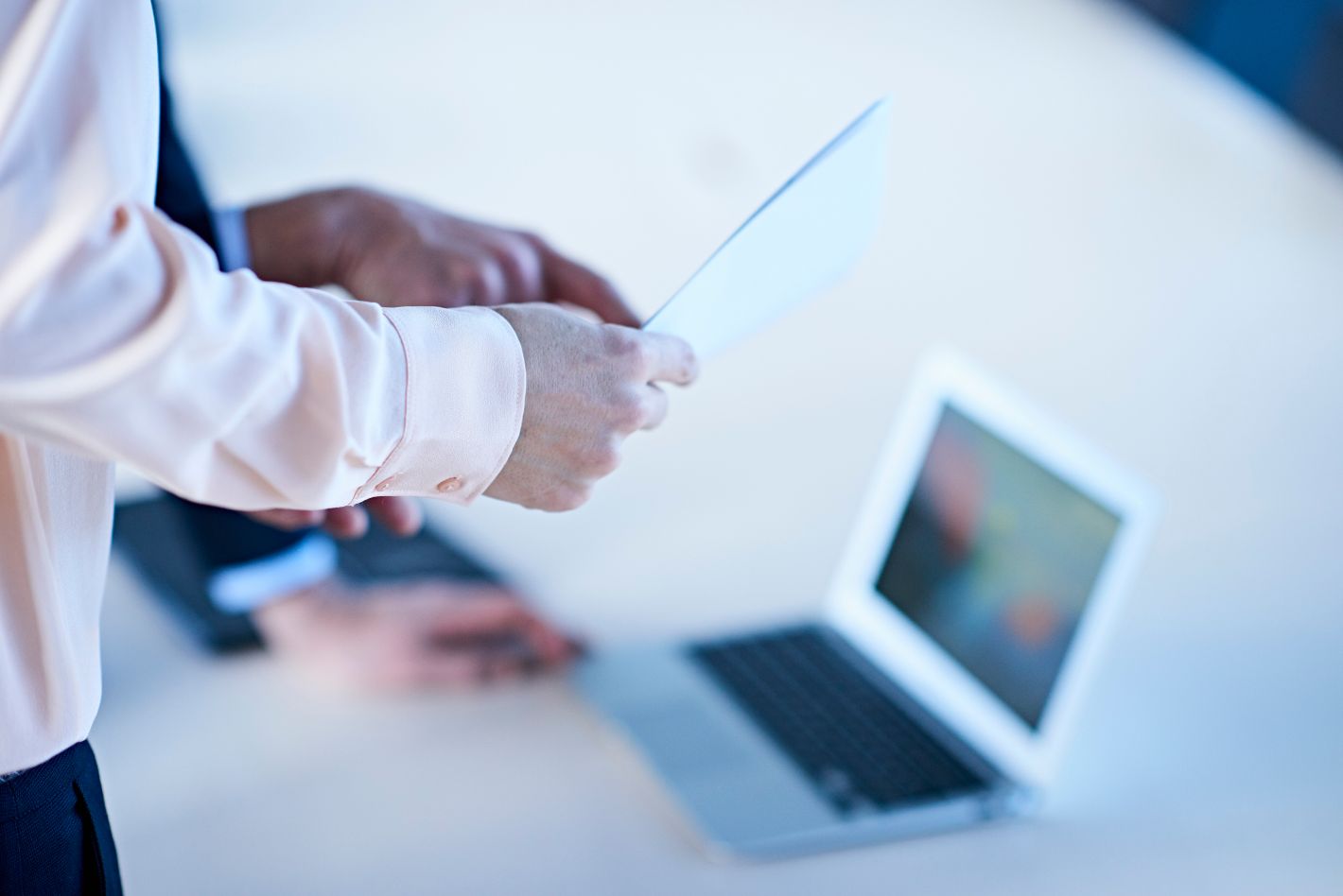 Colleagues examining a tablet together. 