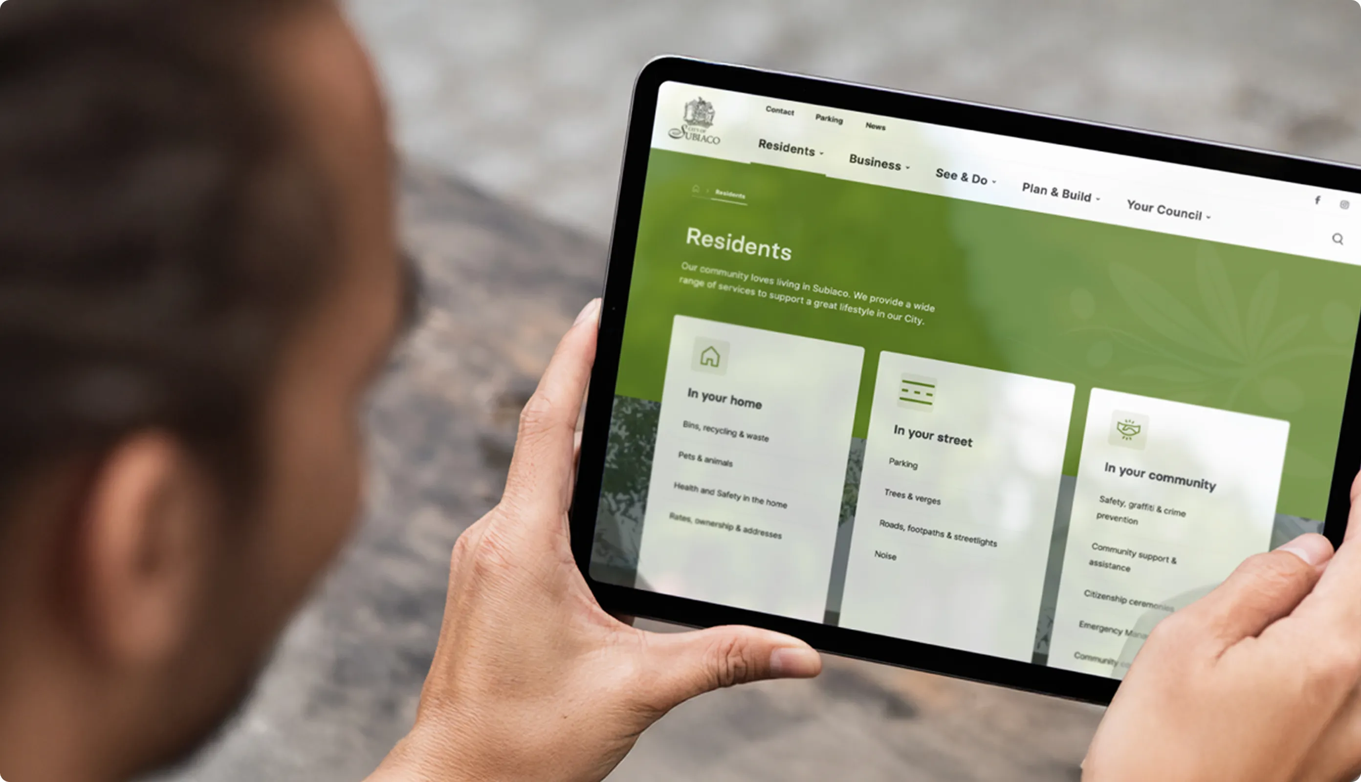Person looking at tablet displaying City of Subiaco website