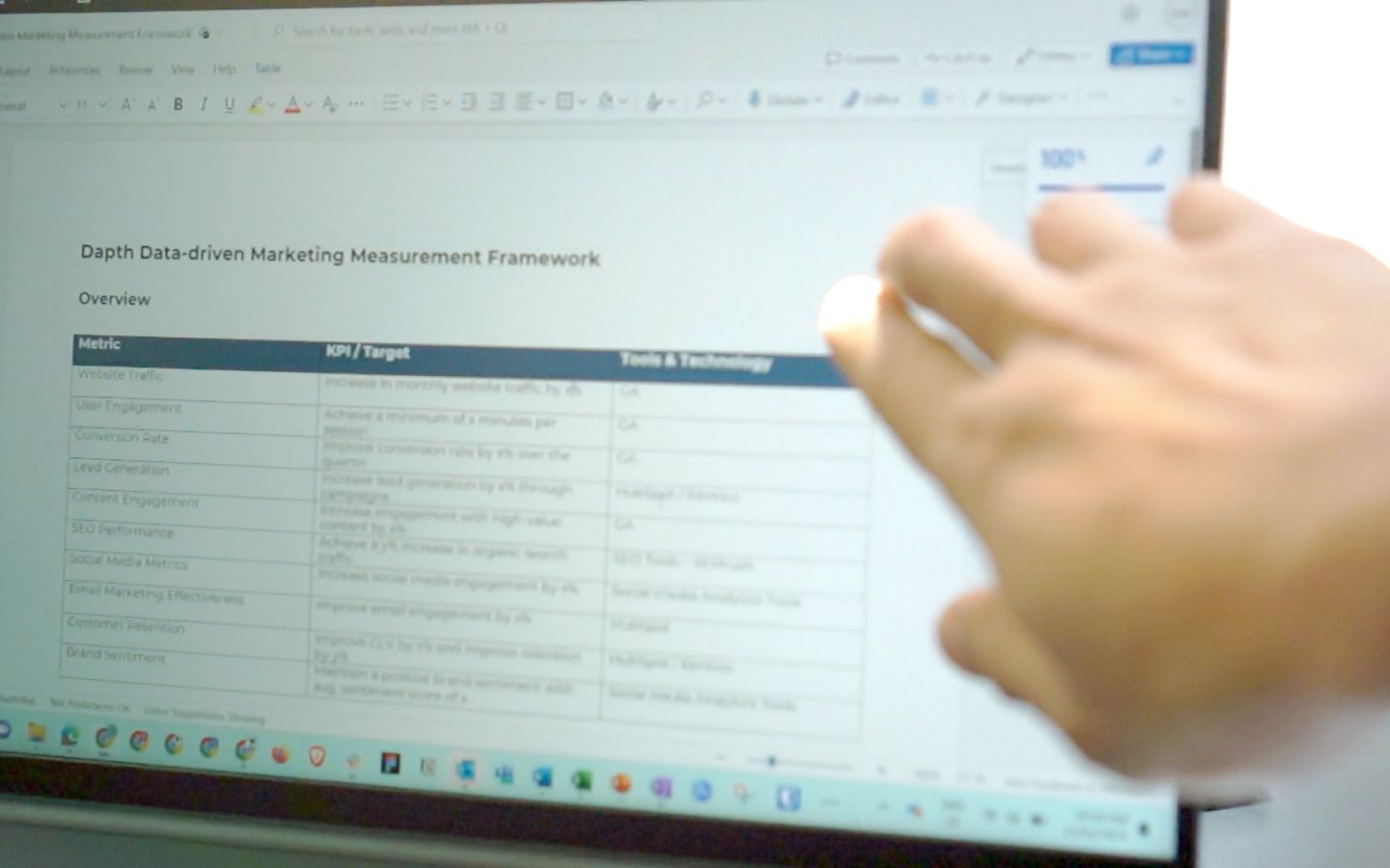 Hand pointing to screen with document displayed