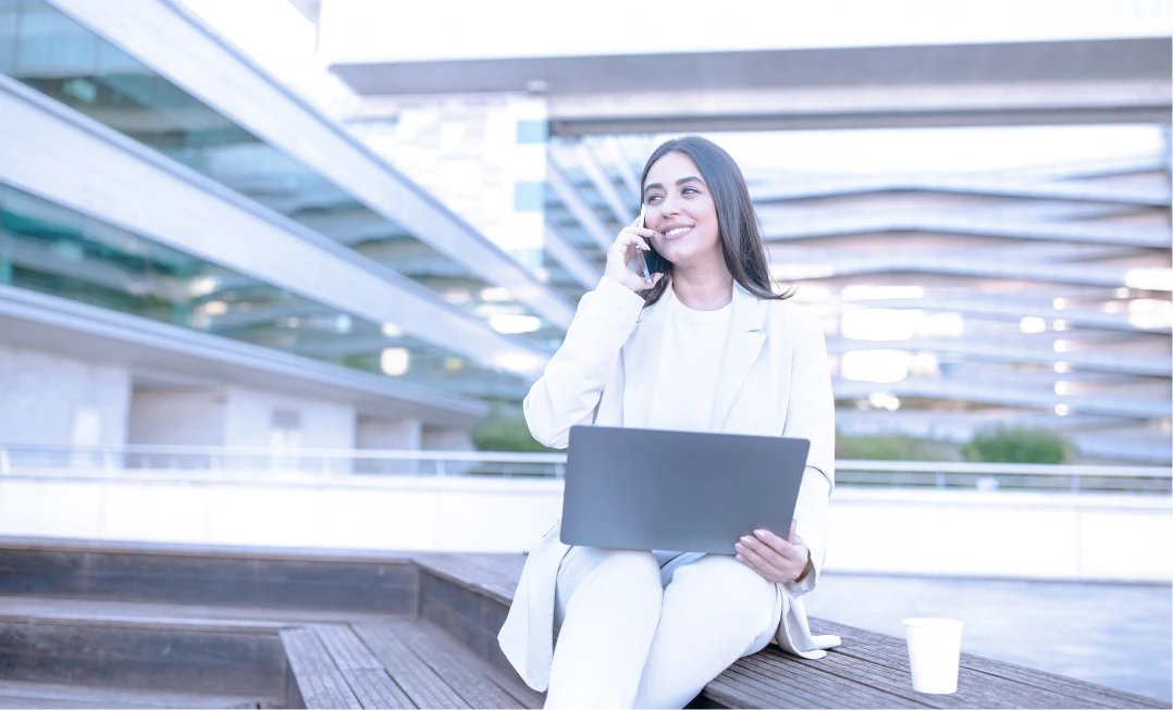 Businesswoman outdoors taking a call with a smartphone
