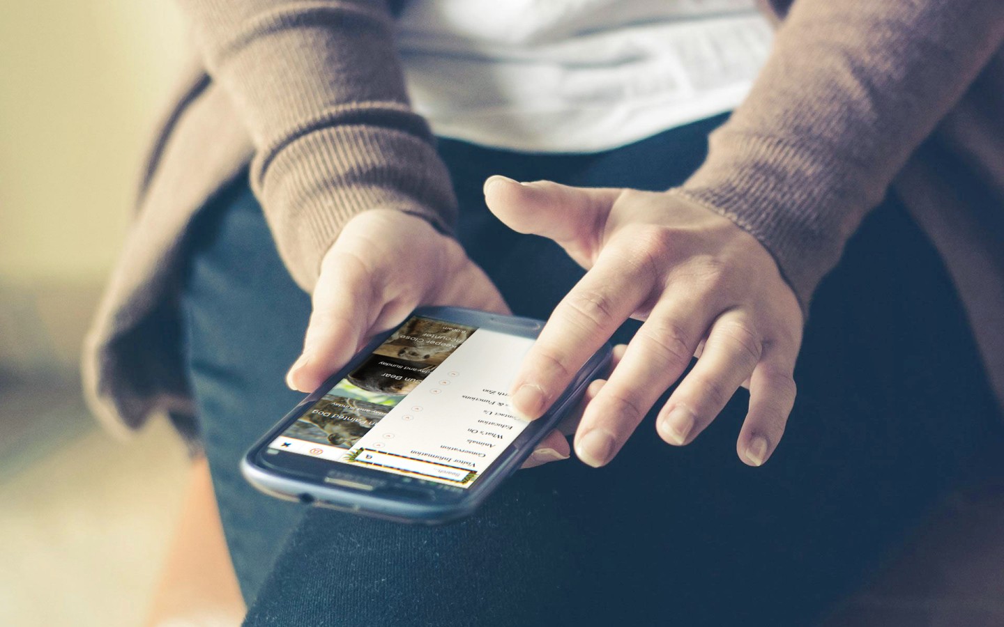 Medium shot of person browsing through a website in a smartphone