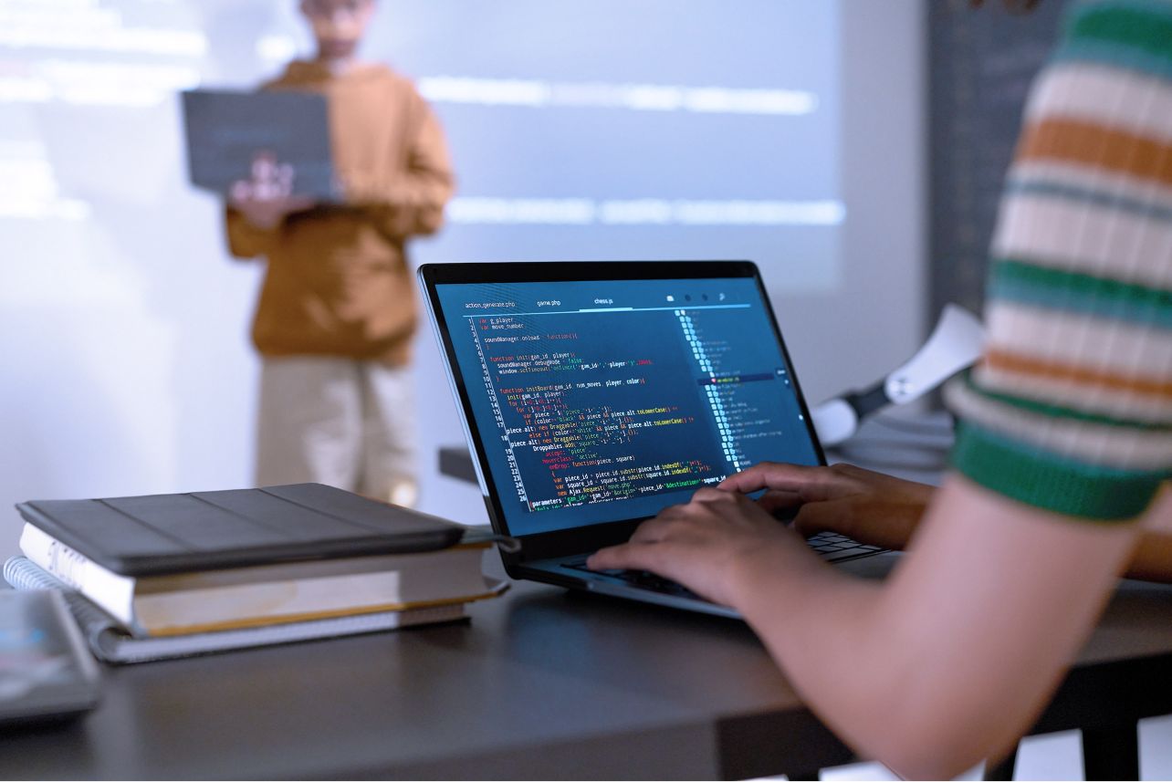 Student learning programming with a laptop. 