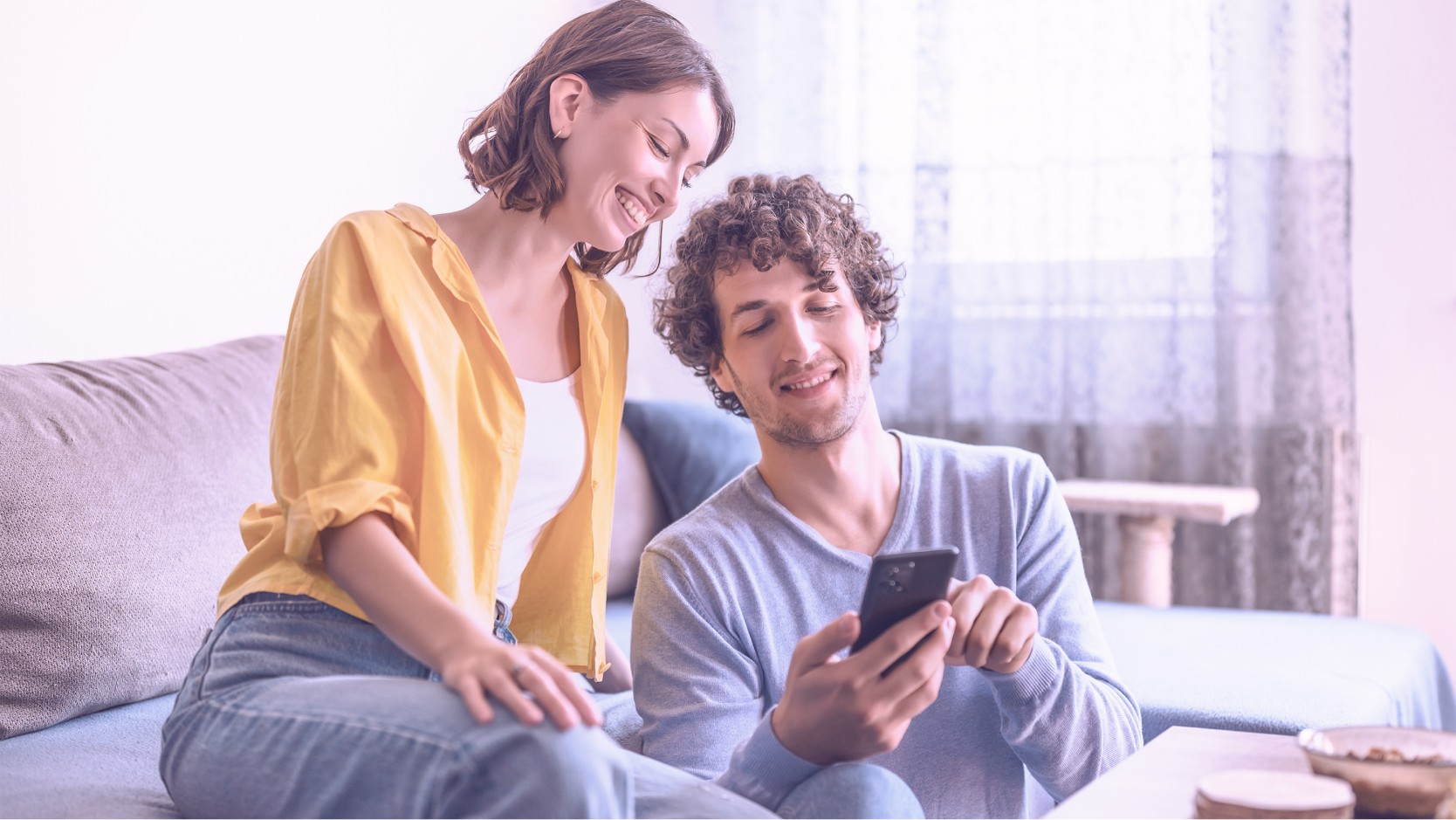 couple in living room with a smartphone