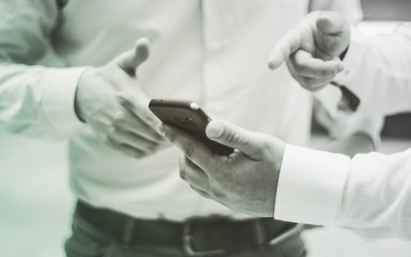 Two men pointing to mobile phone