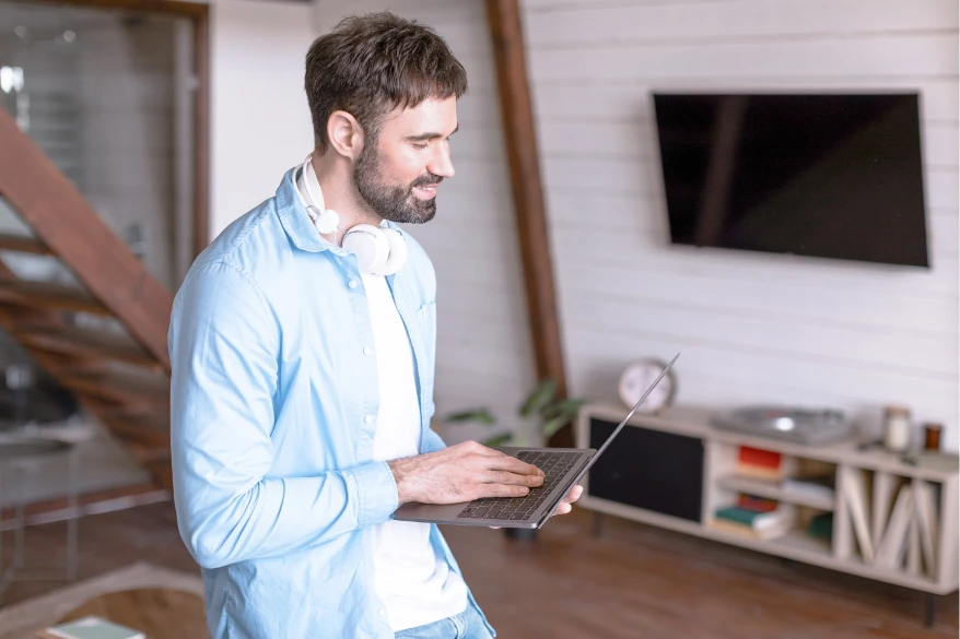 Man with laptop in living room