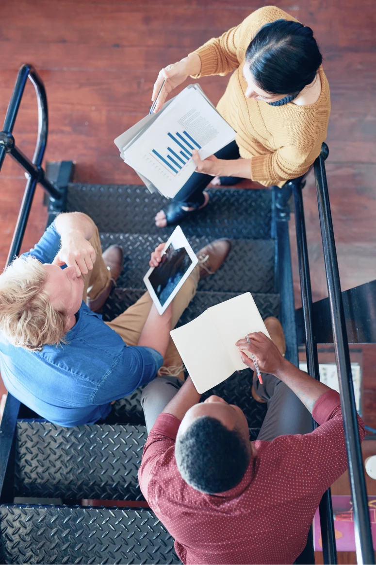 Top down view of colleagues at a brainstorming discussion