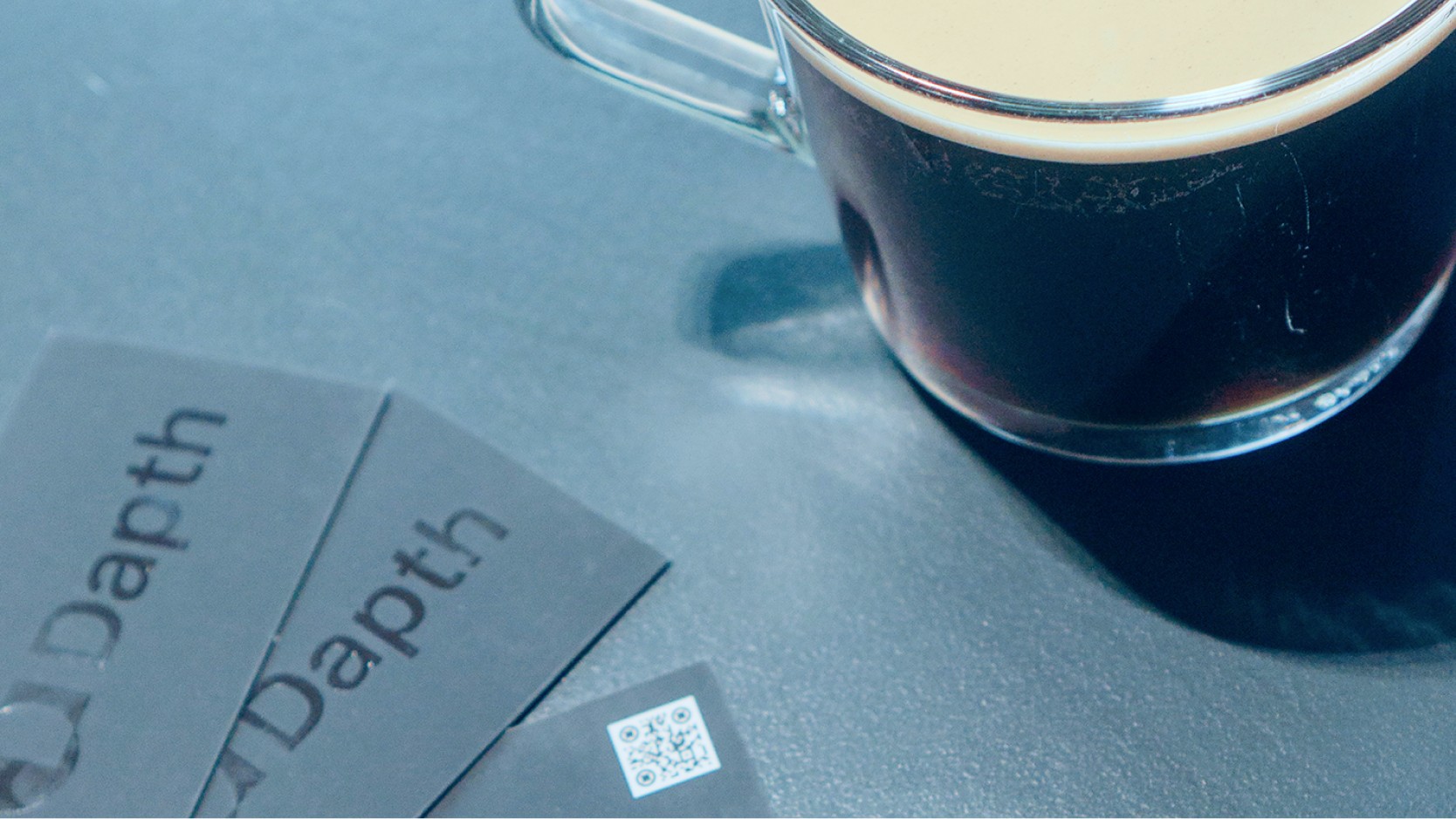 Dapth business cards on a coffee table