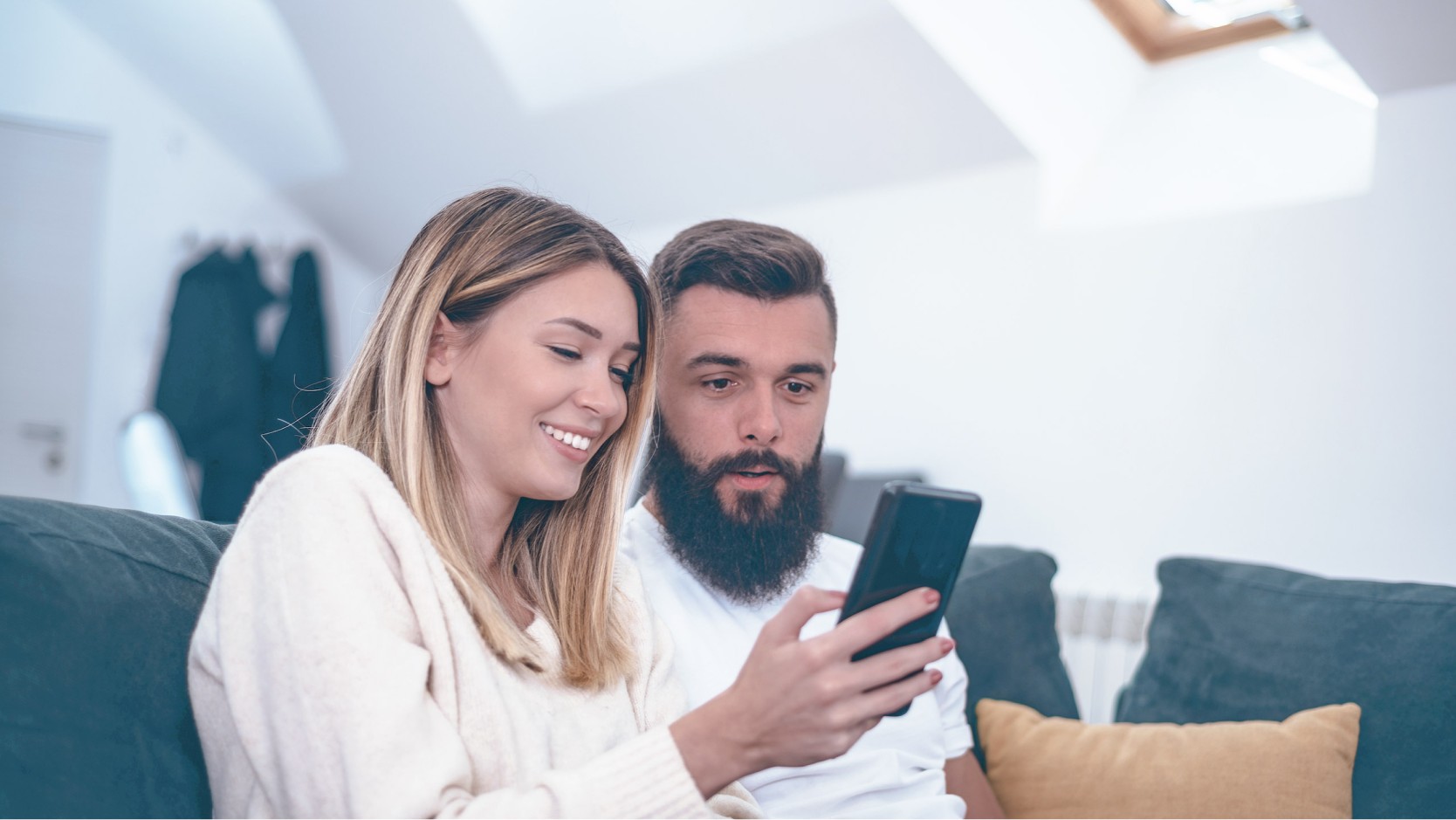 couple in living room with a smartphone