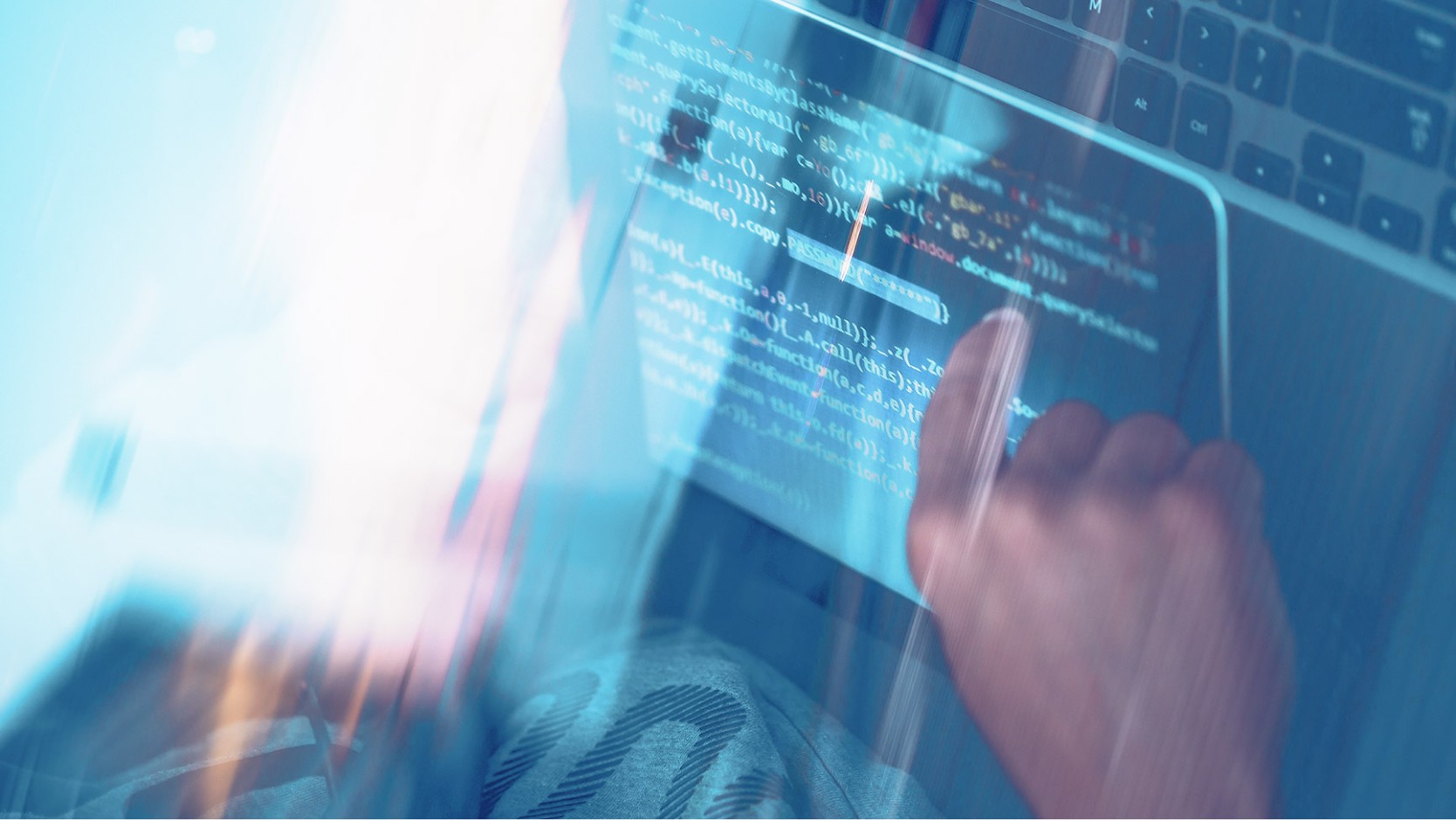 Person typing on laptop keyboard in professional workspace