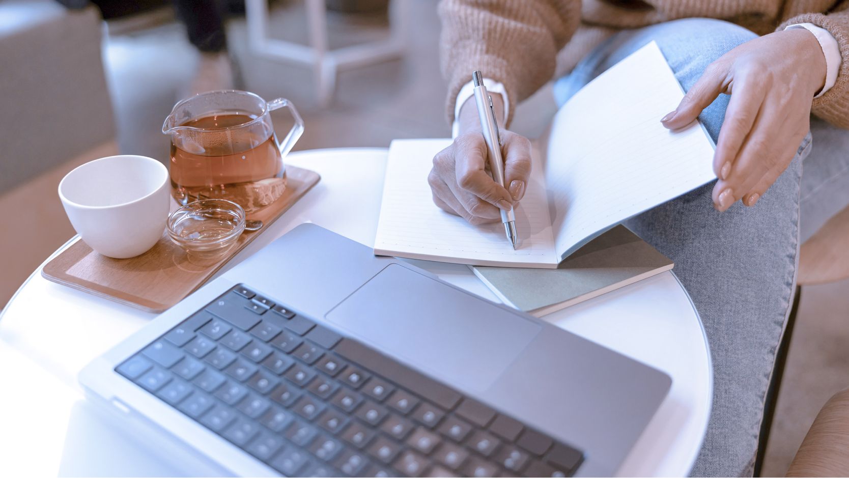 Woman planning and writing social media strategy on notepad.