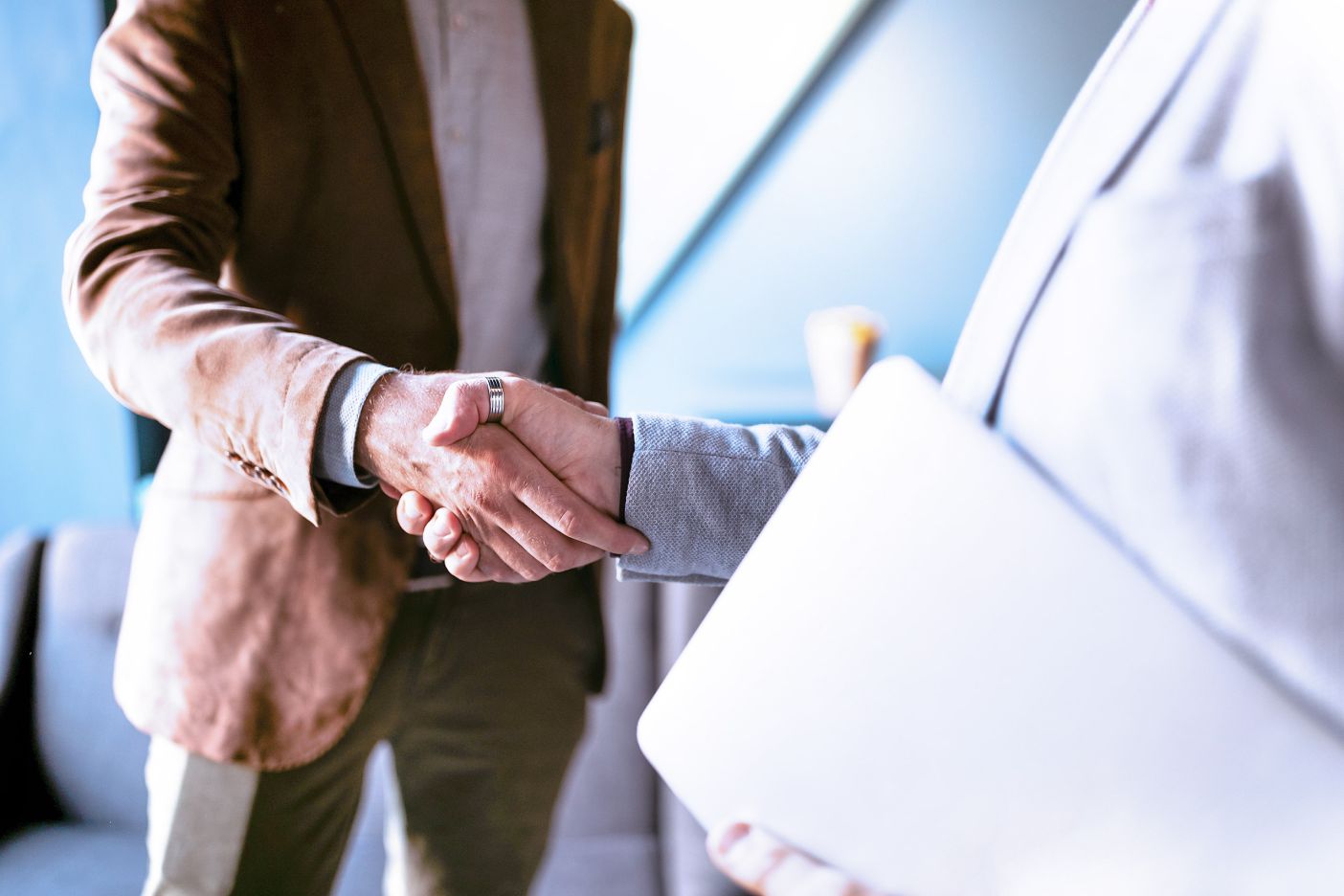 Two business men in handshake, sealing agreement. 