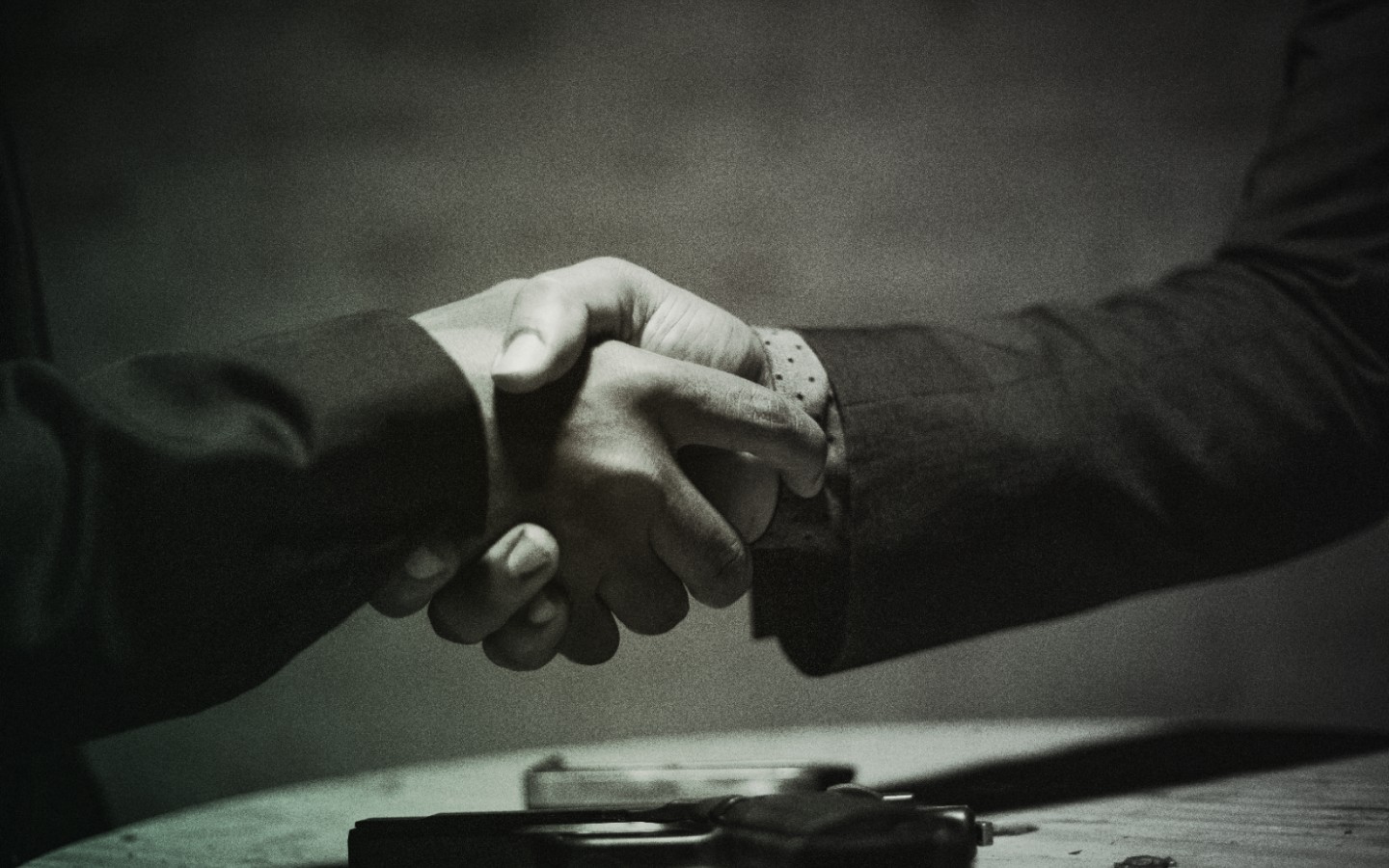 A medium shot of two people shaking hands.