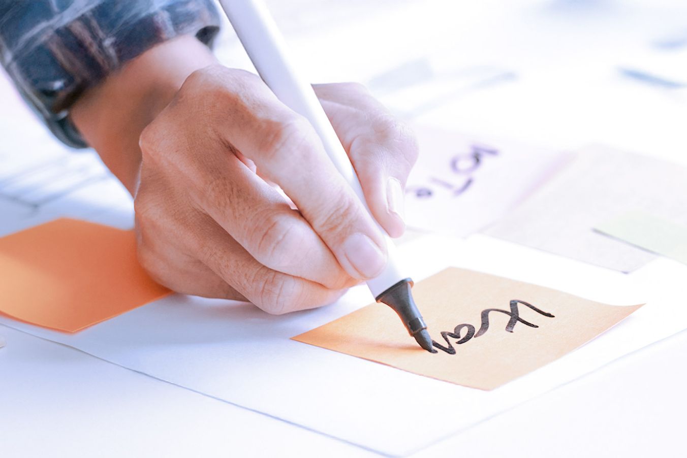 Close up of hand writing on stickynote