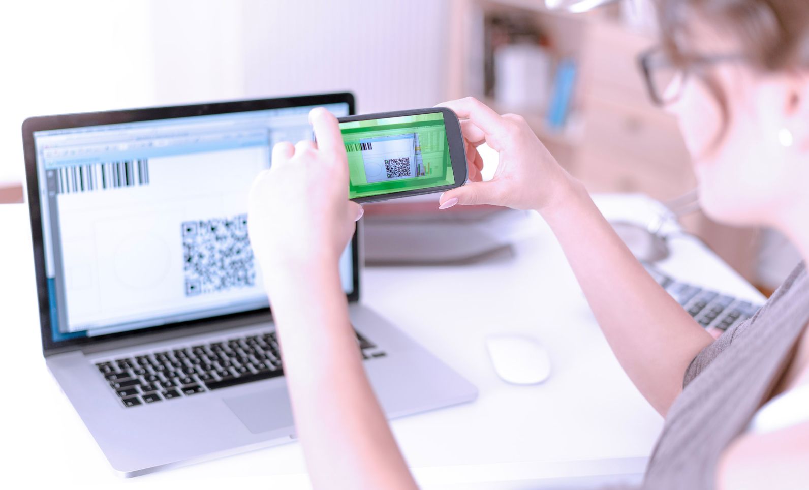Woman scanning QR code with her smartphone.