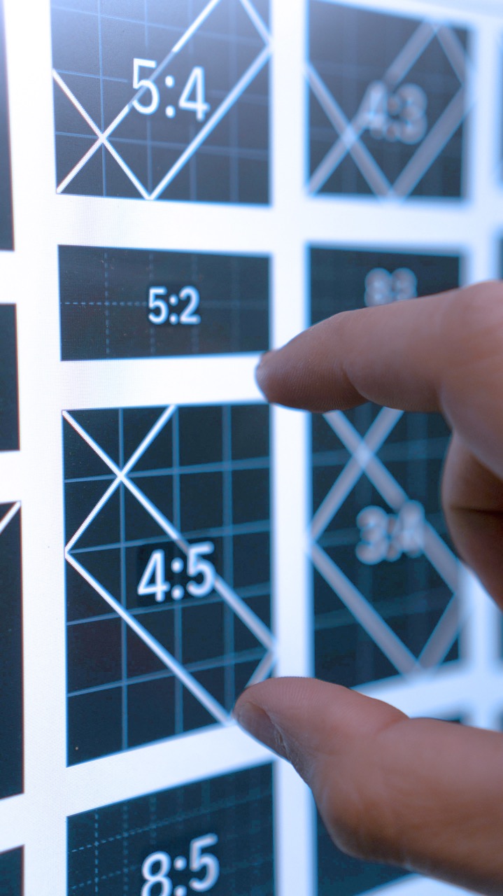 Close up of hand pointing at a user interface elements on a screen. 