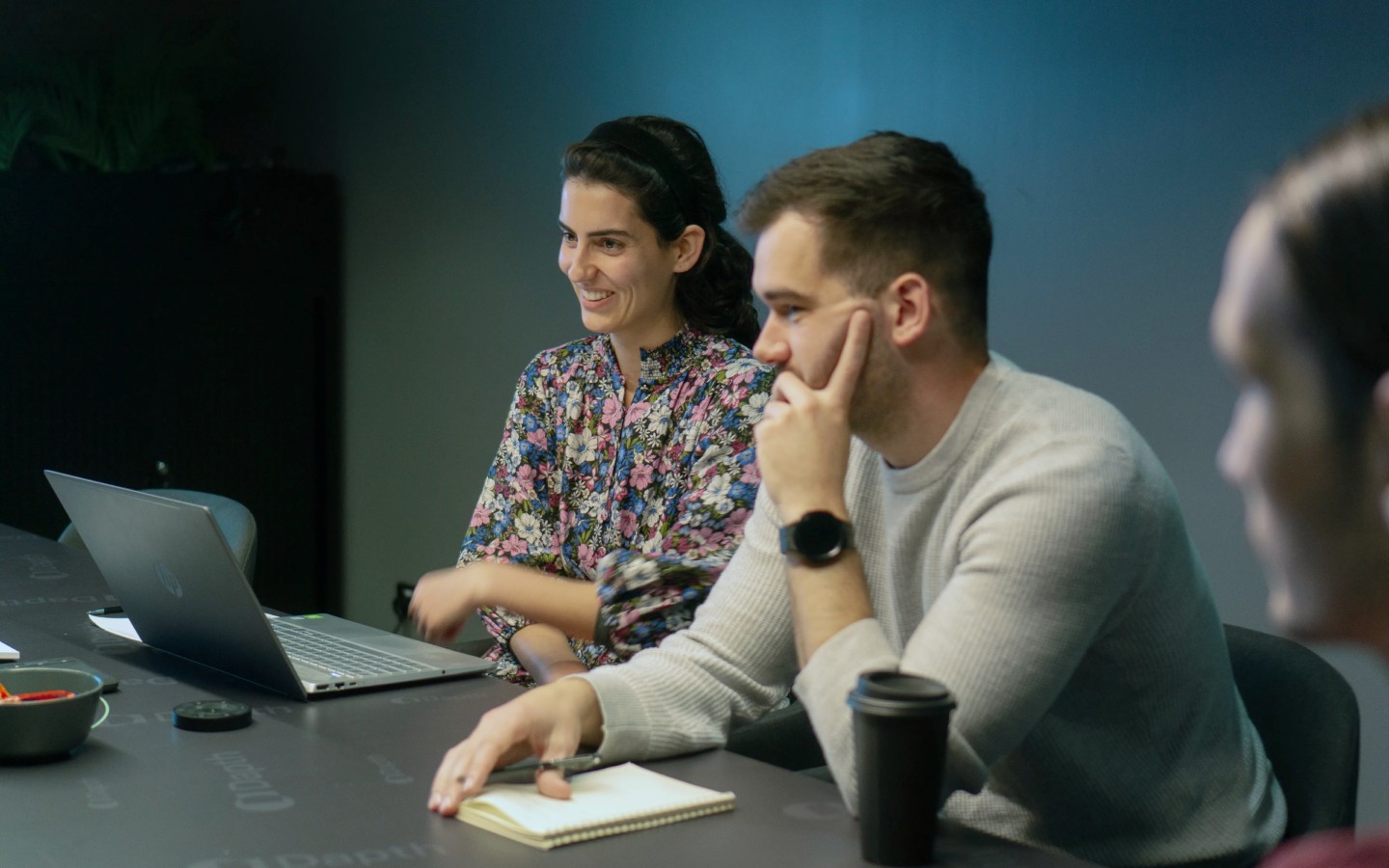 Man and woman sitting in work meeting discussing project