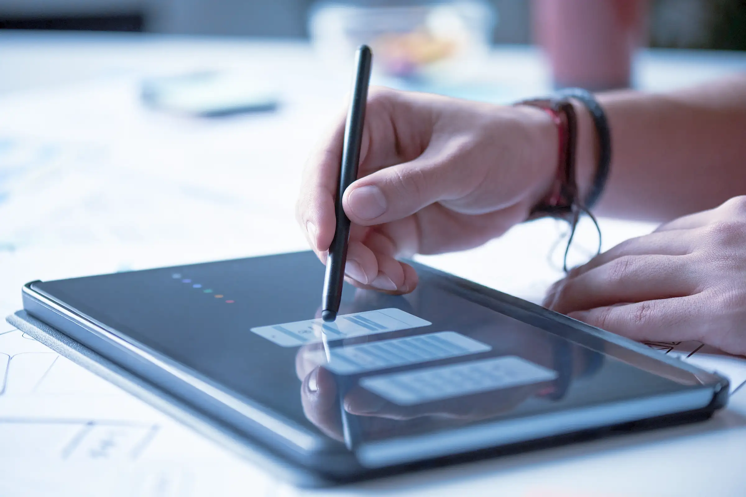 A colleague inspecting wireframes on a tablet. 