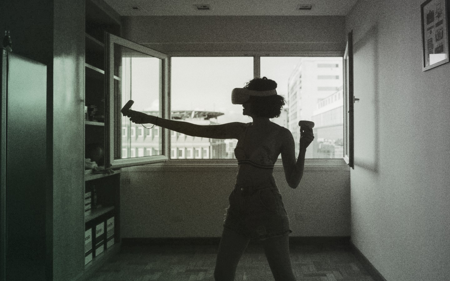 Image of woman with VR headset in an apartment unit.