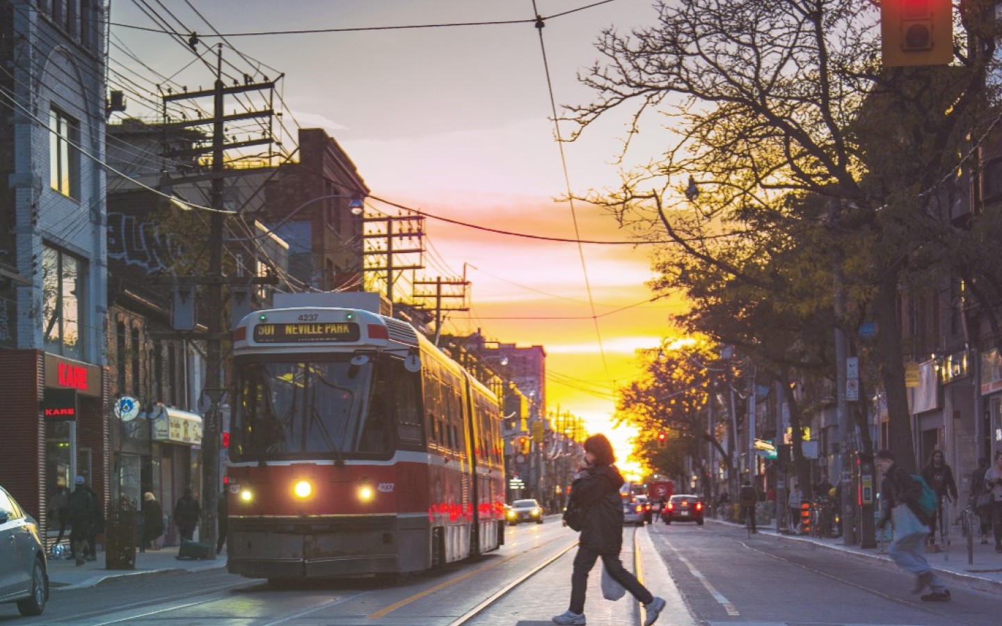 Street scene with pedestrians, tram and cars