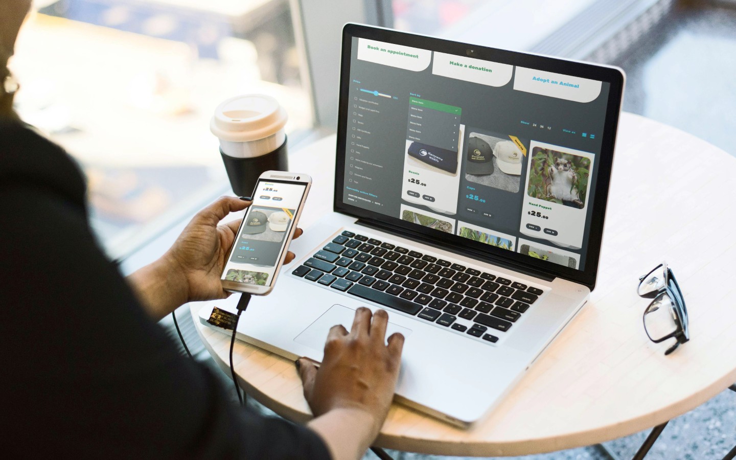 Medium shot of person browsing through a website in a laptop and smartphone