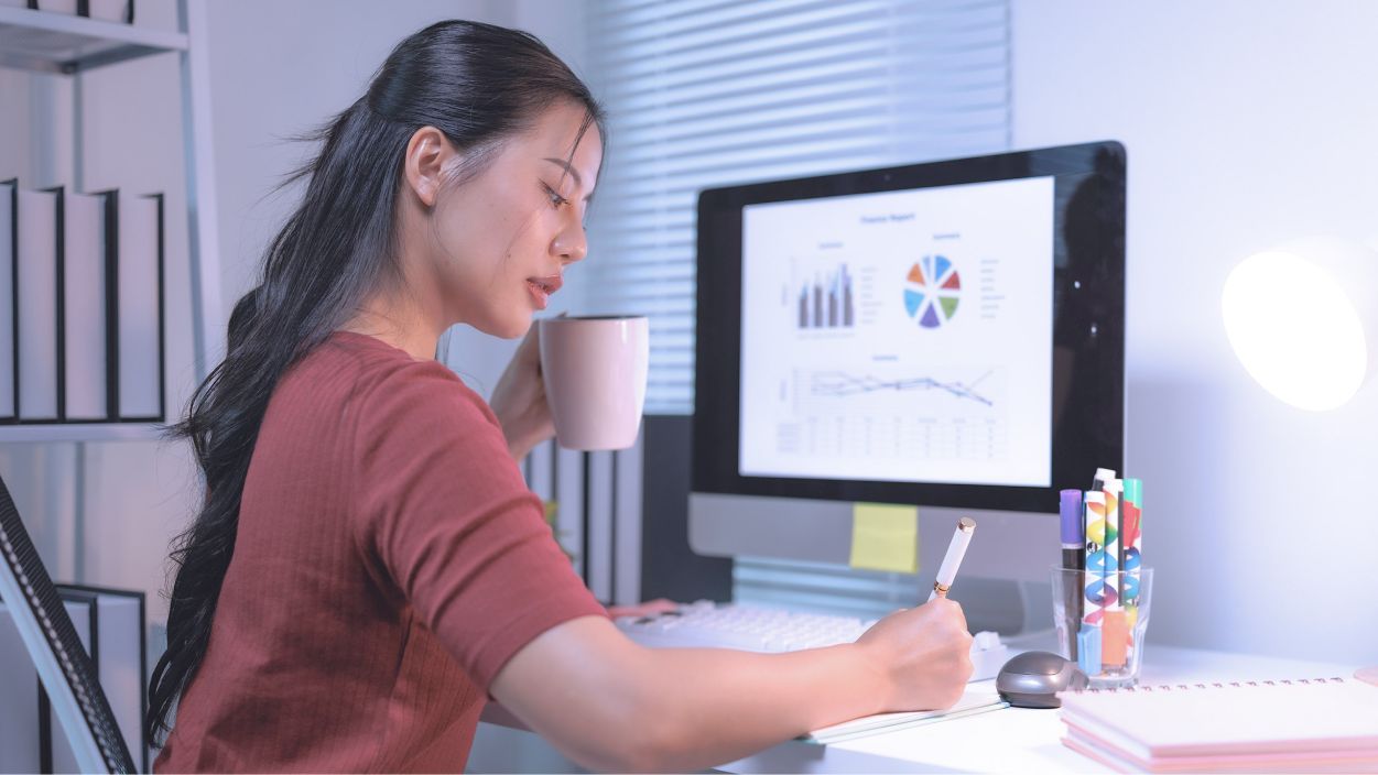 Design student note-taking in a study room.