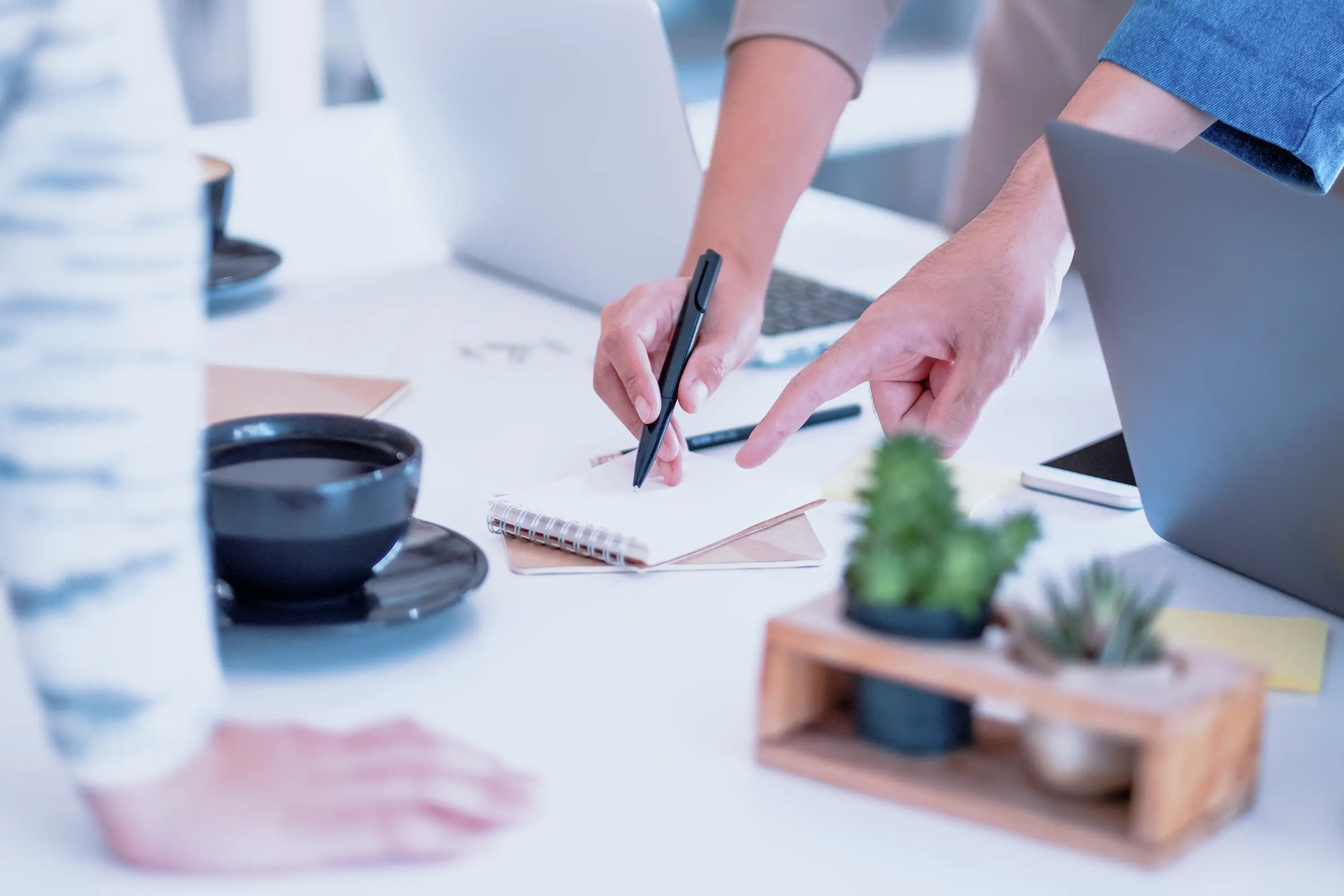 Colleagues examining notes at a workshop session. 
