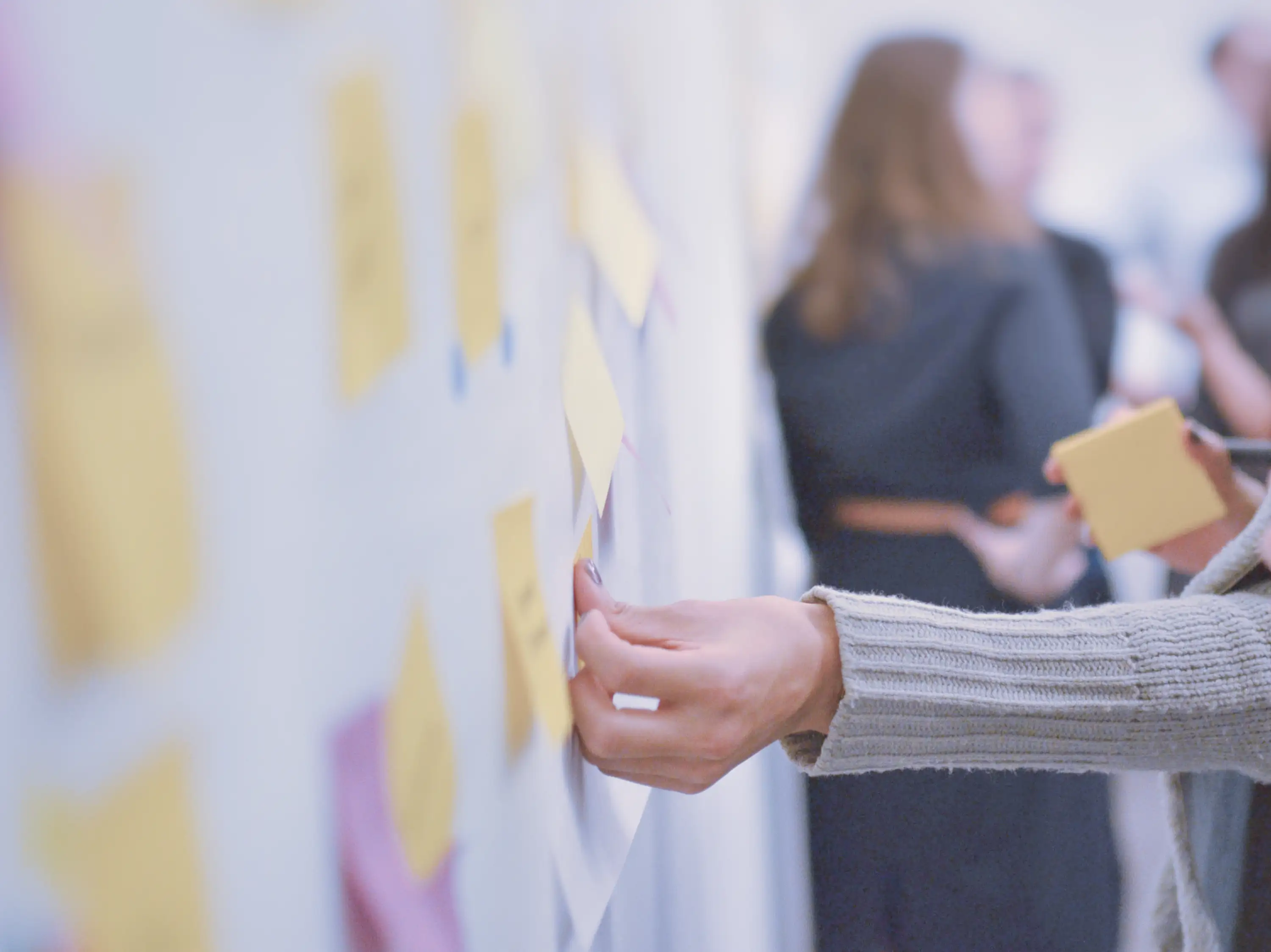 Colleagues in a workshop session putting sticky notes