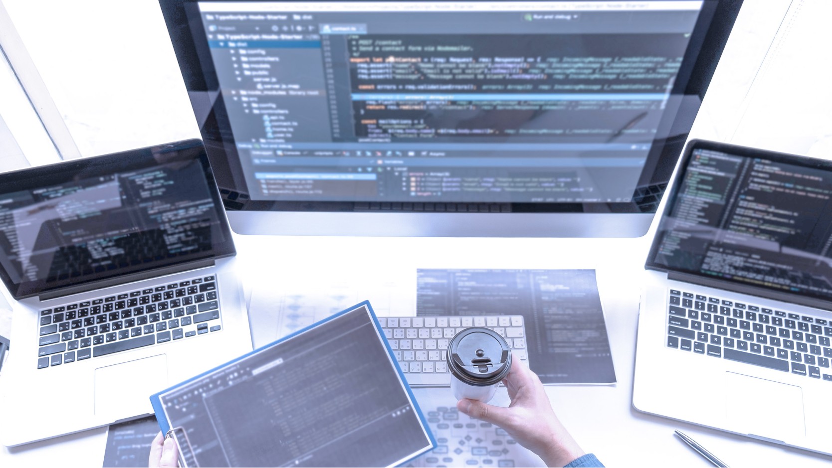 Software engineer at desk with multiple monitors and development environment