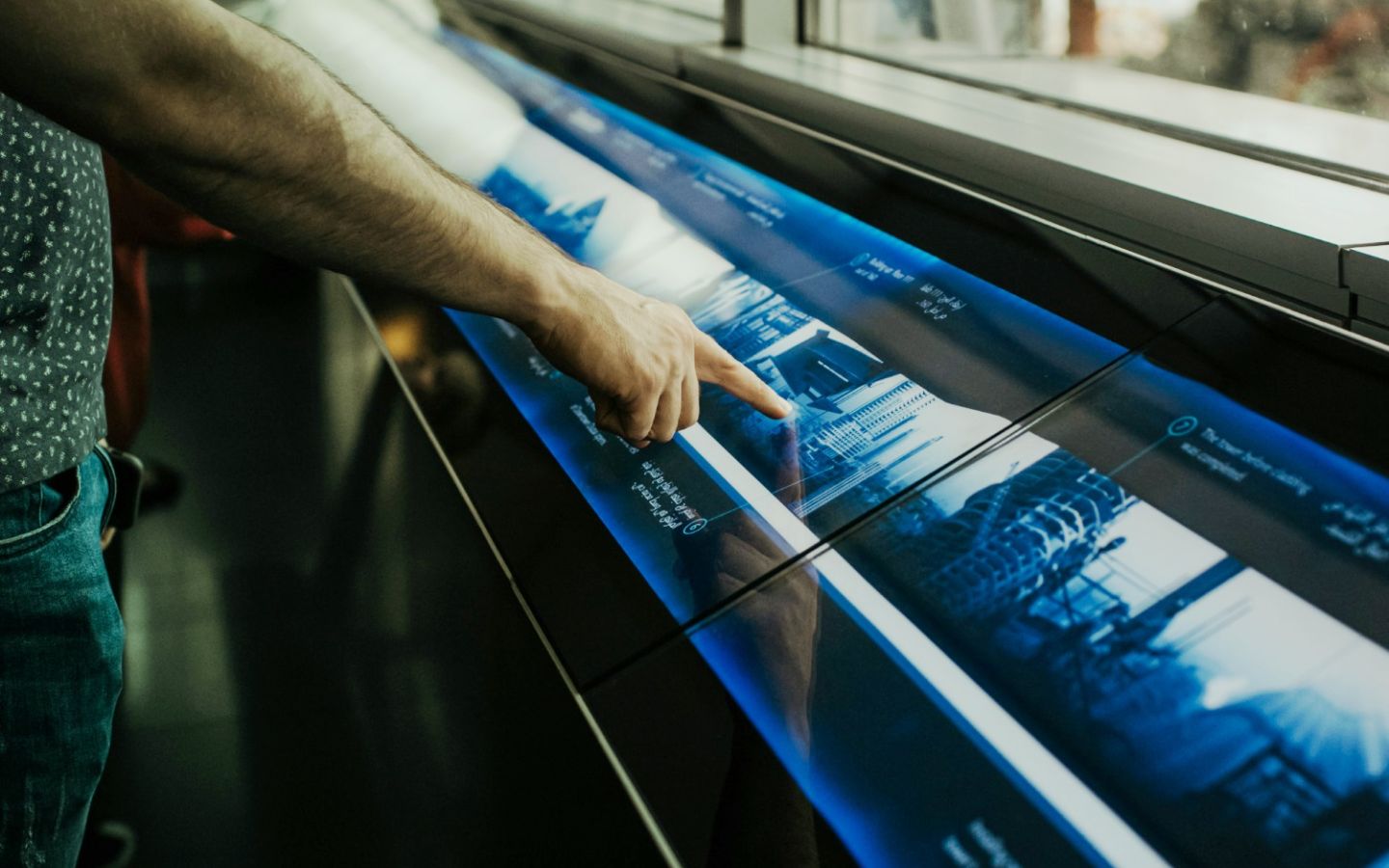 Image of person interacting with a touchscreen