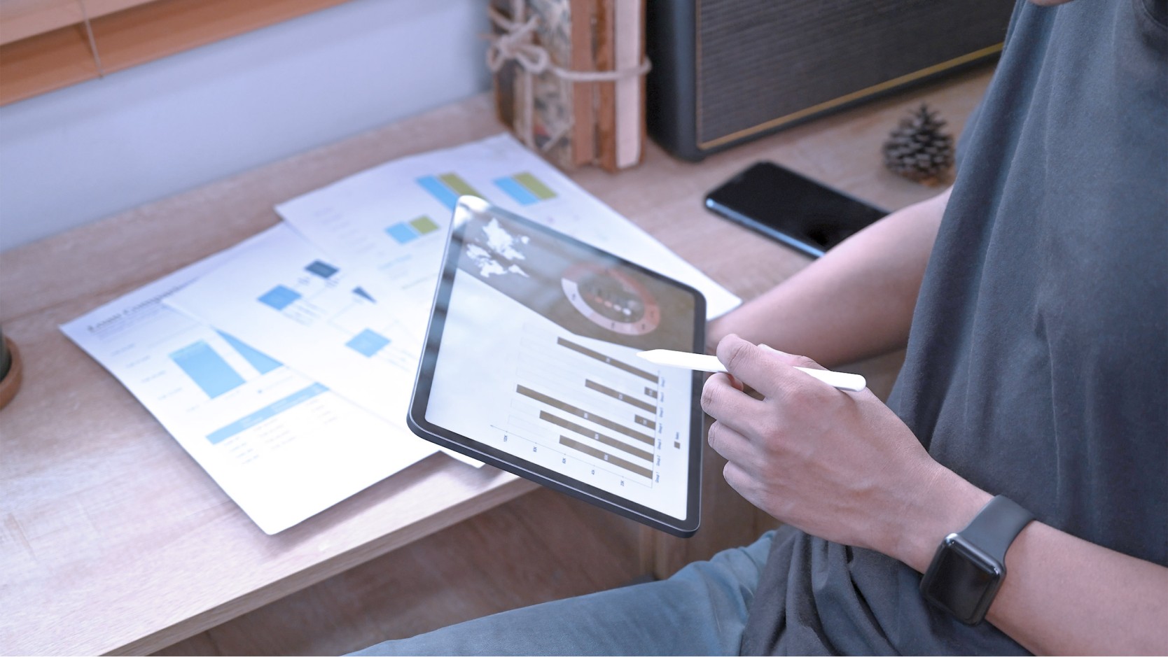 man working on a tablet with stylus in an office.
