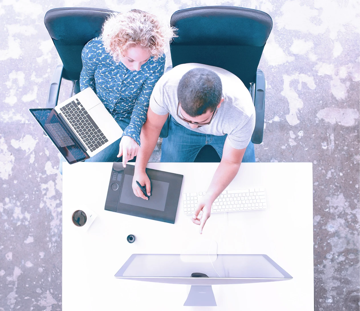 Top down of colleagues working together on a brightly lit office.