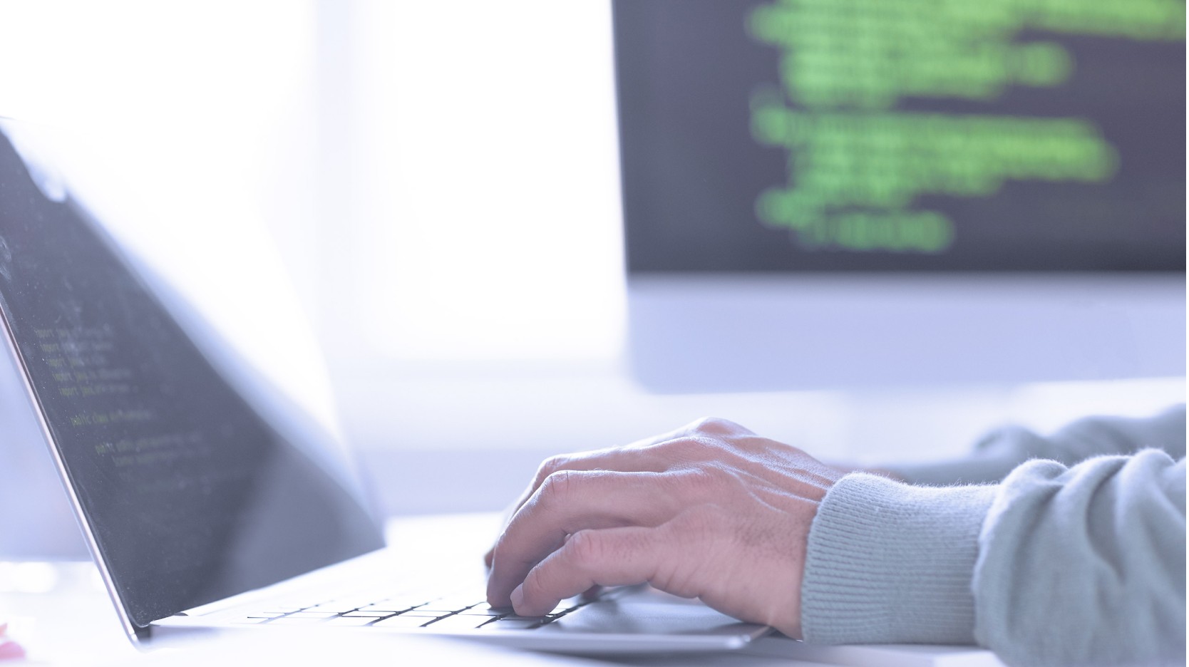 hand typing on a laptop