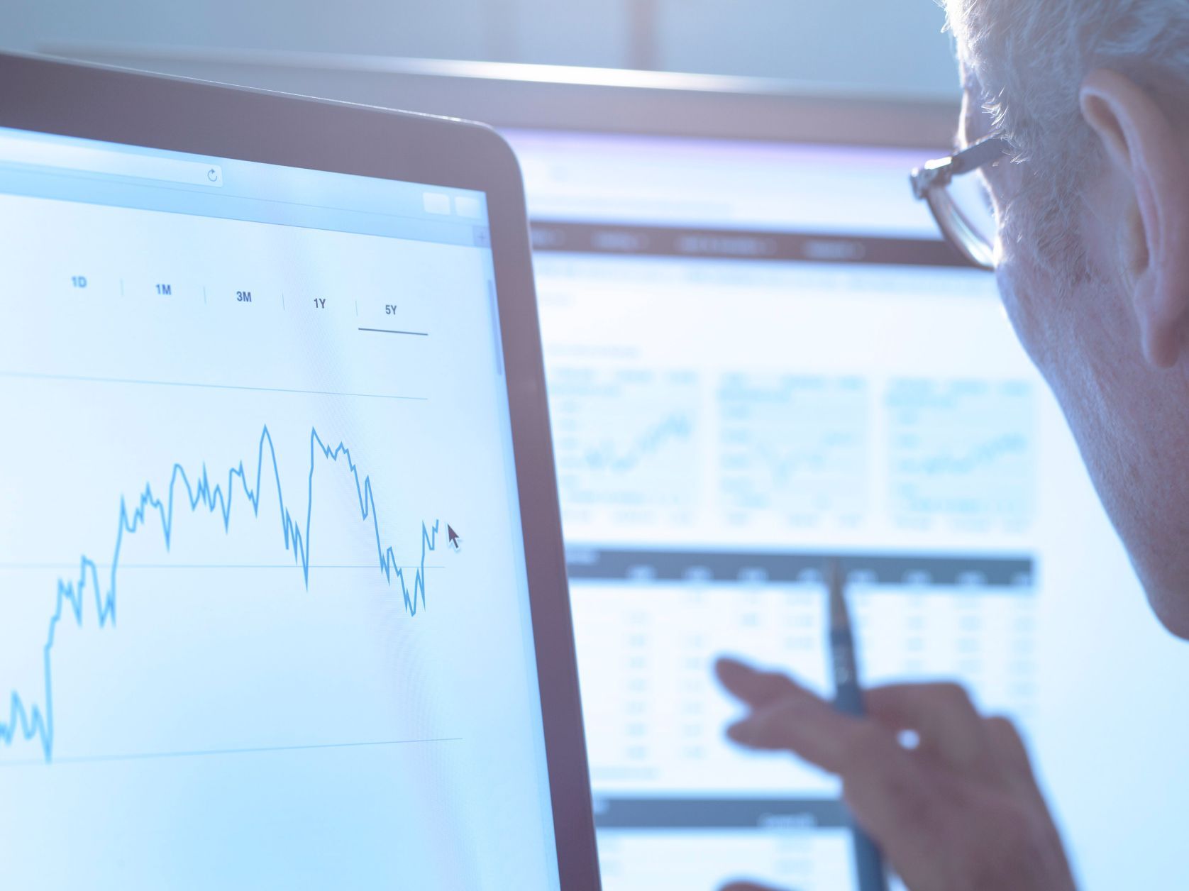 Colleague examining charts on computer screen